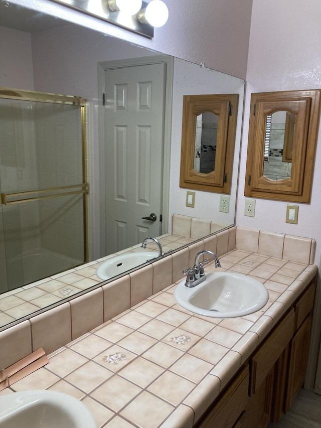 bathroom featuring vanity and an enclosed shower