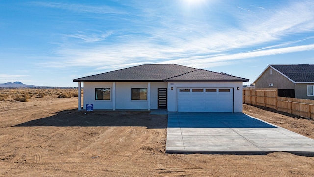 view of front facade with a garage and a mountain view