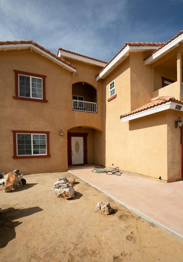 back of house with a patio and stucco siding