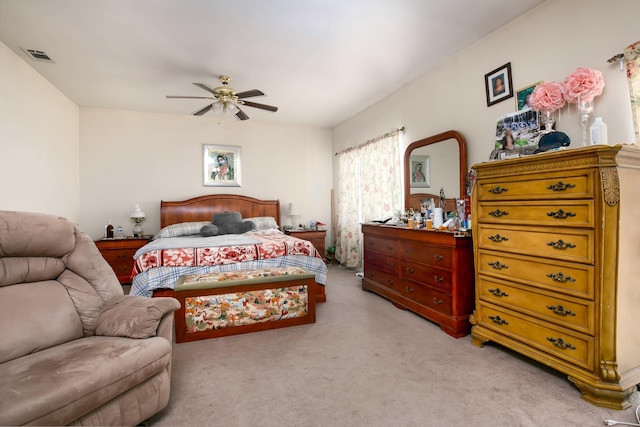 bedroom with a ceiling fan, light colored carpet, and visible vents