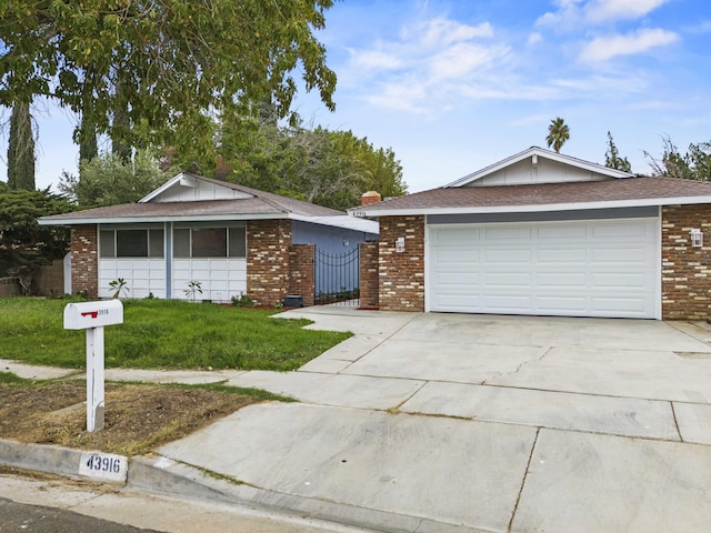 ranch-style home with a garage and a front lawn