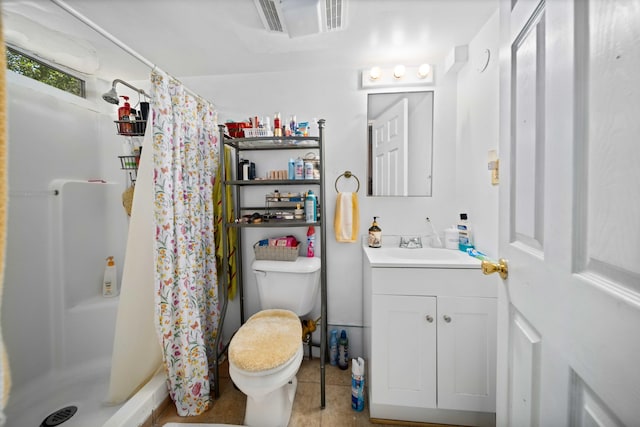 bathroom with tile patterned floors, toilet, vanity, and a shower with shower curtain