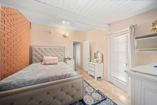 tiled bedroom with beam ceiling, an AC wall unit, and brick wall