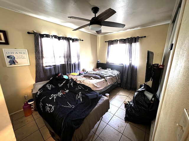 bedroom with tile patterned flooring and a ceiling fan