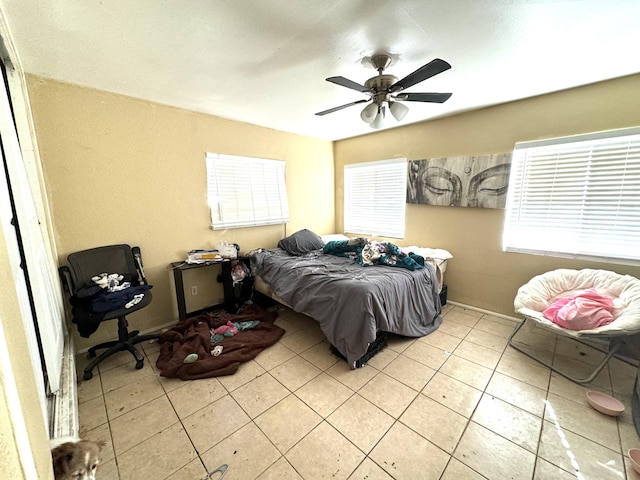 bedroom with ceiling fan and light tile patterned floors