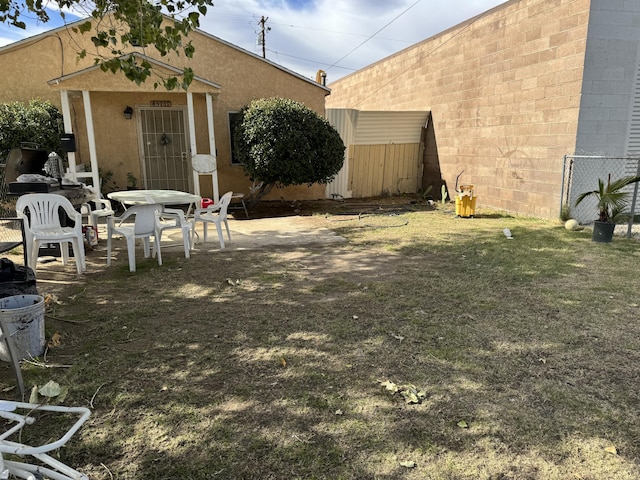 view of yard featuring a patio and fence