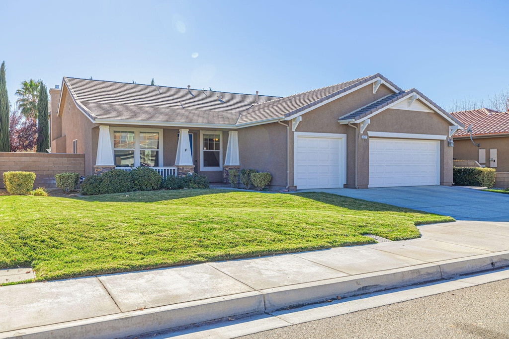 ranch-style home with a garage and a front yard