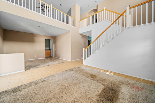 interior space featuring tile patterned floors and a high ceiling