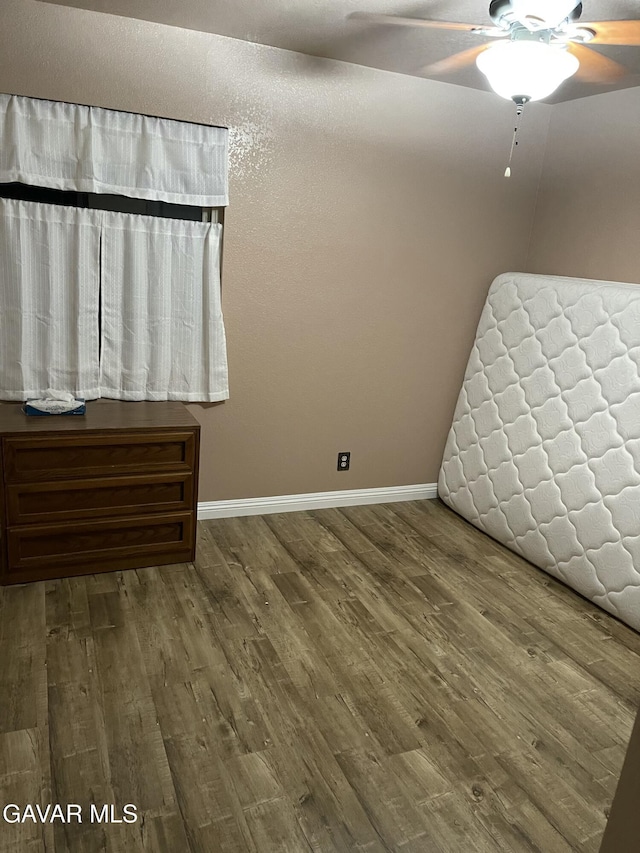 3657 Imperial Ave, Rosamond, CA 93560 - unfurnished bedroom featuring wood finished floors and ceiling fan