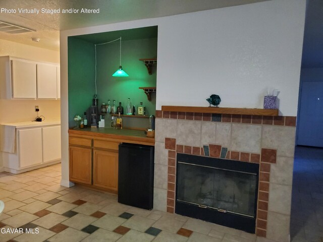 3657 Imperial Ave, Rosamond, CA 93560 - bar featuring fridge, a glass covered fireplace, and hanging light fixtures
