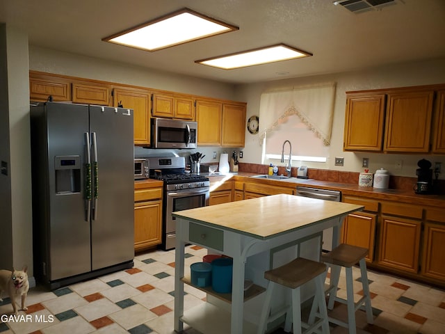 3657 Imperial Ave, Rosamond, CA 93560 - kitchen with stainless steel appliances, light flooring, and brown cabinets