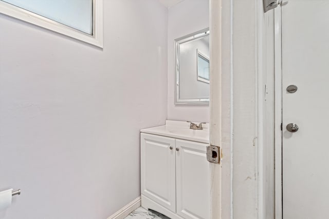 44129 Date Ave, Lancaster, CA 93534 - bathroom with marble finish flooring, vanity, and baseboards