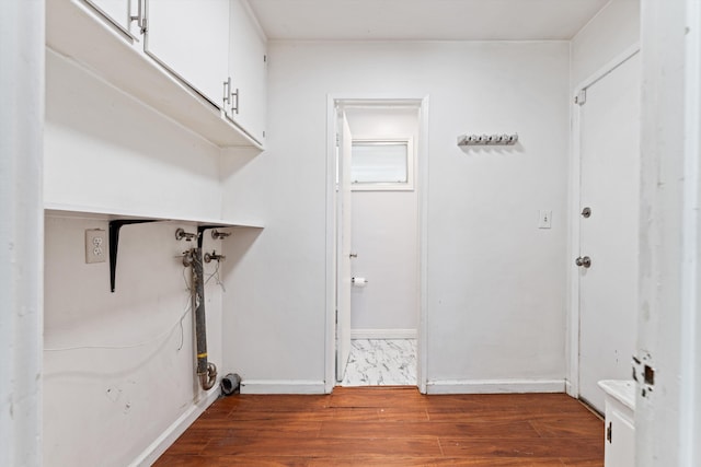 44129 Date Ave, Lancaster, CA 93534 - clothes washing area with cabinet space, wood finished floors, and baseboards