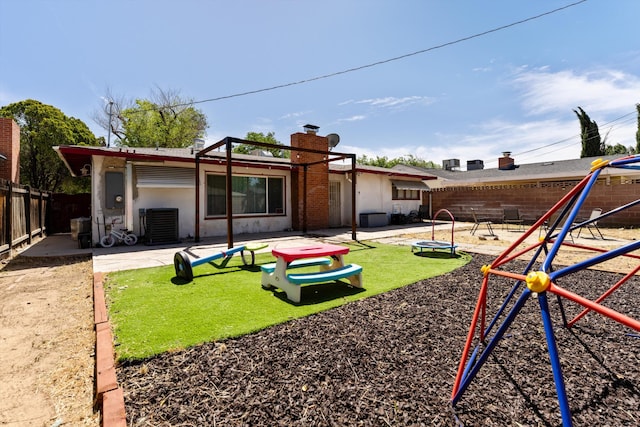 44129 Date Ave, Lancaster, CA 93534 - rear view of property with a playground, a fenced backyard, a patio area, and a chimney