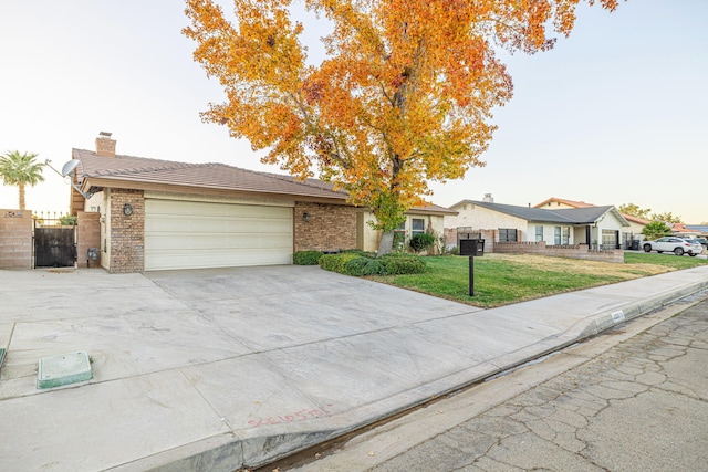 single story home featuring a garage and a front lawn