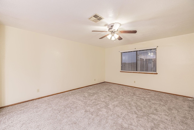 carpeted empty room featuring ceiling fan