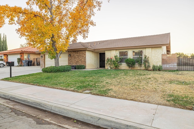 single story home with a front lawn and a garage