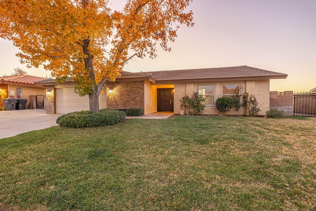 view of front of home featuring a yard and a garage