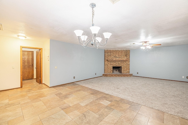 unfurnished living room featuring ceiling fan with notable chandelier, light colored carpet, and a brick fireplace