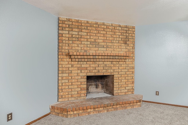 interior details with carpet floors and a brick fireplace