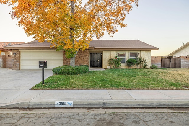 view of front of property featuring a garage and a yard