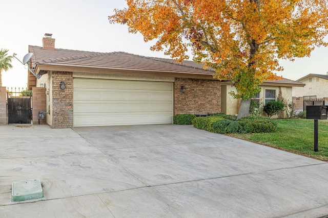 ranch-style home with a front lawn and a garage