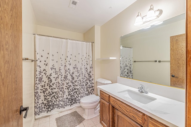 bathroom featuring tile patterned flooring, vanity, and toilet