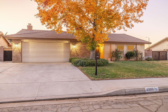 view of front of house featuring a yard and a garage