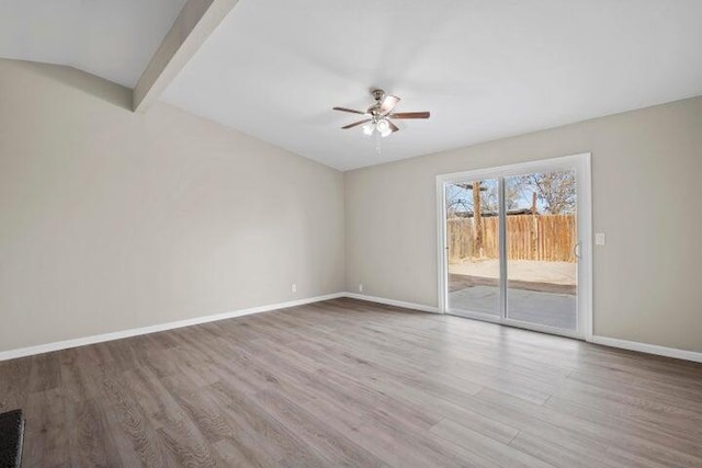 spare room featuring baseboards, a ceiling fan, and wood finished floors