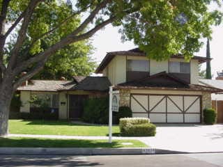 view of front of property with a garage and a front yard