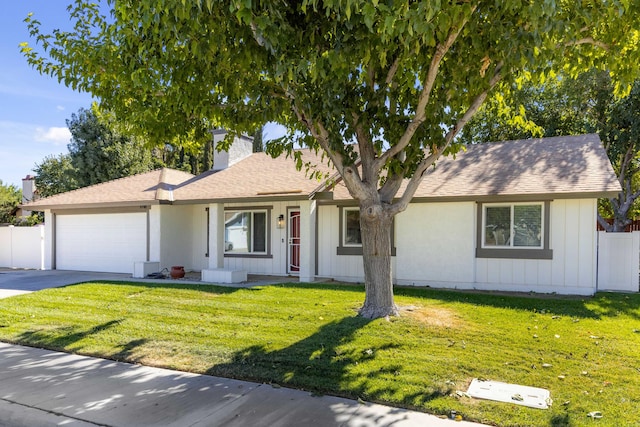 single story home featuring a garage and a front lawn