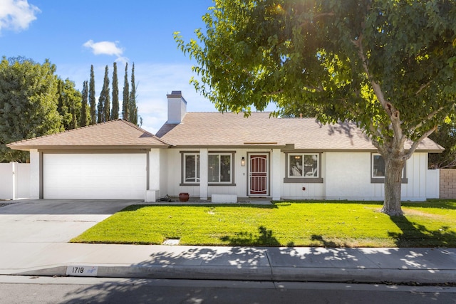 ranch-style home with a garage and a front yard