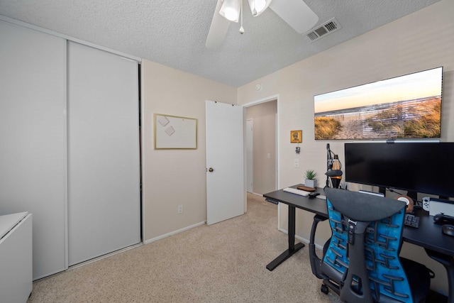 office area with ceiling fan and a textured ceiling