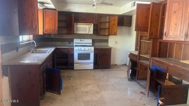 38520 E 12th St, Palmdale, CA 93550 - kitchen featuring white appliances, ceiling fan, brown cabinetry, and light countertops