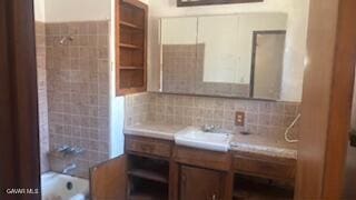 38520 E 12th St, Palmdale, CA 93550 - bathroom with vanity, shower / bathtub combination, and tasteful backsplash