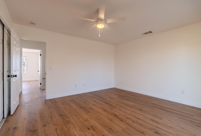 empty room featuring ceiling fan and wood-type flooring