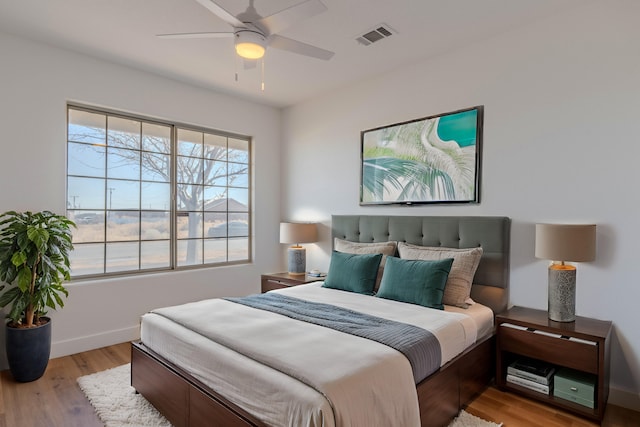 bedroom with light hardwood / wood-style flooring and ceiling fan