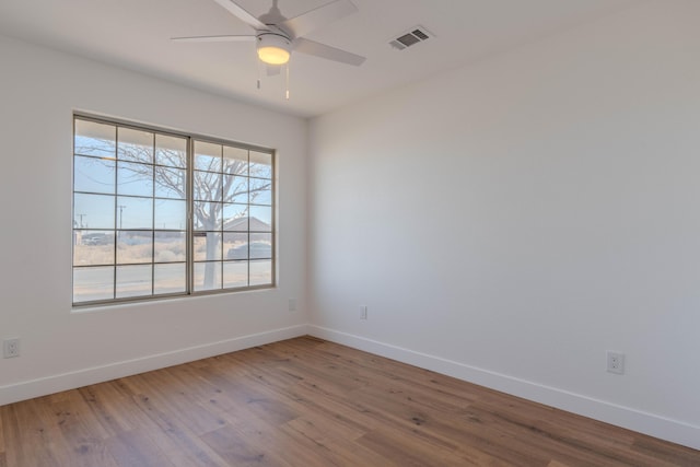 spare room with ceiling fan and hardwood / wood-style floors