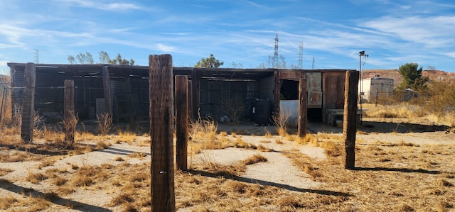 view of gate with an outdoor structure