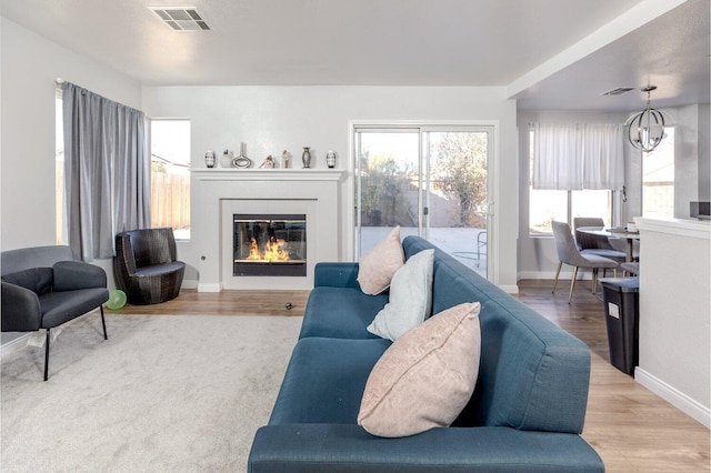 living room featuring light hardwood / wood-style floors and a chandelier