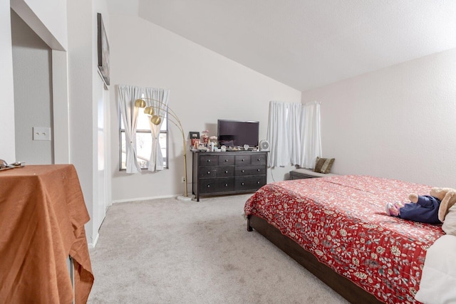 bedroom with light colored carpet and vaulted ceiling