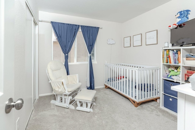 carpeted bedroom with a nursery area