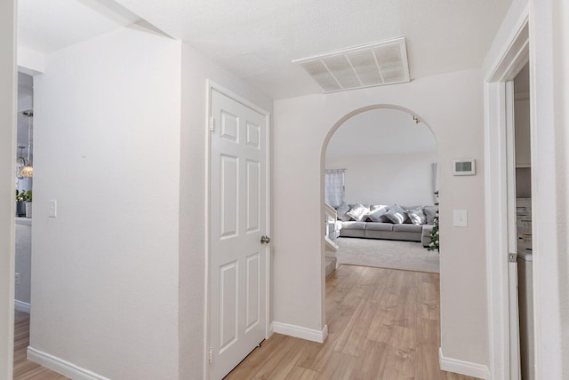 corridor with light hardwood / wood-style floors