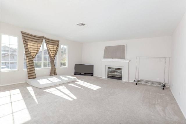 unfurnished living room featuring light colored carpet