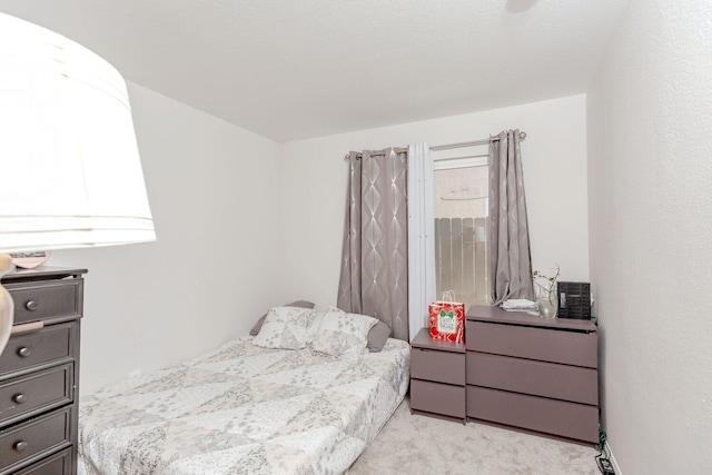 bedroom featuring light carpet