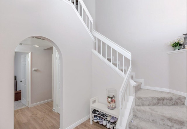 stairs featuring hardwood / wood-style floors