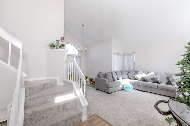 living room featuring a notable chandelier and high vaulted ceiling