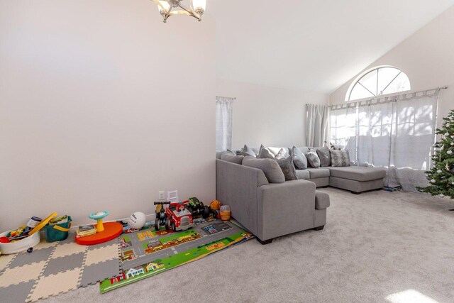 carpeted living room with high vaulted ceiling