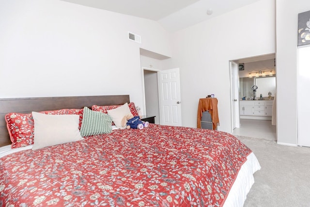 carpeted bedroom featuring connected bathroom and lofted ceiling