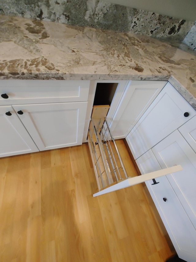 interior space featuring white cabinets and light hardwood / wood-style floors